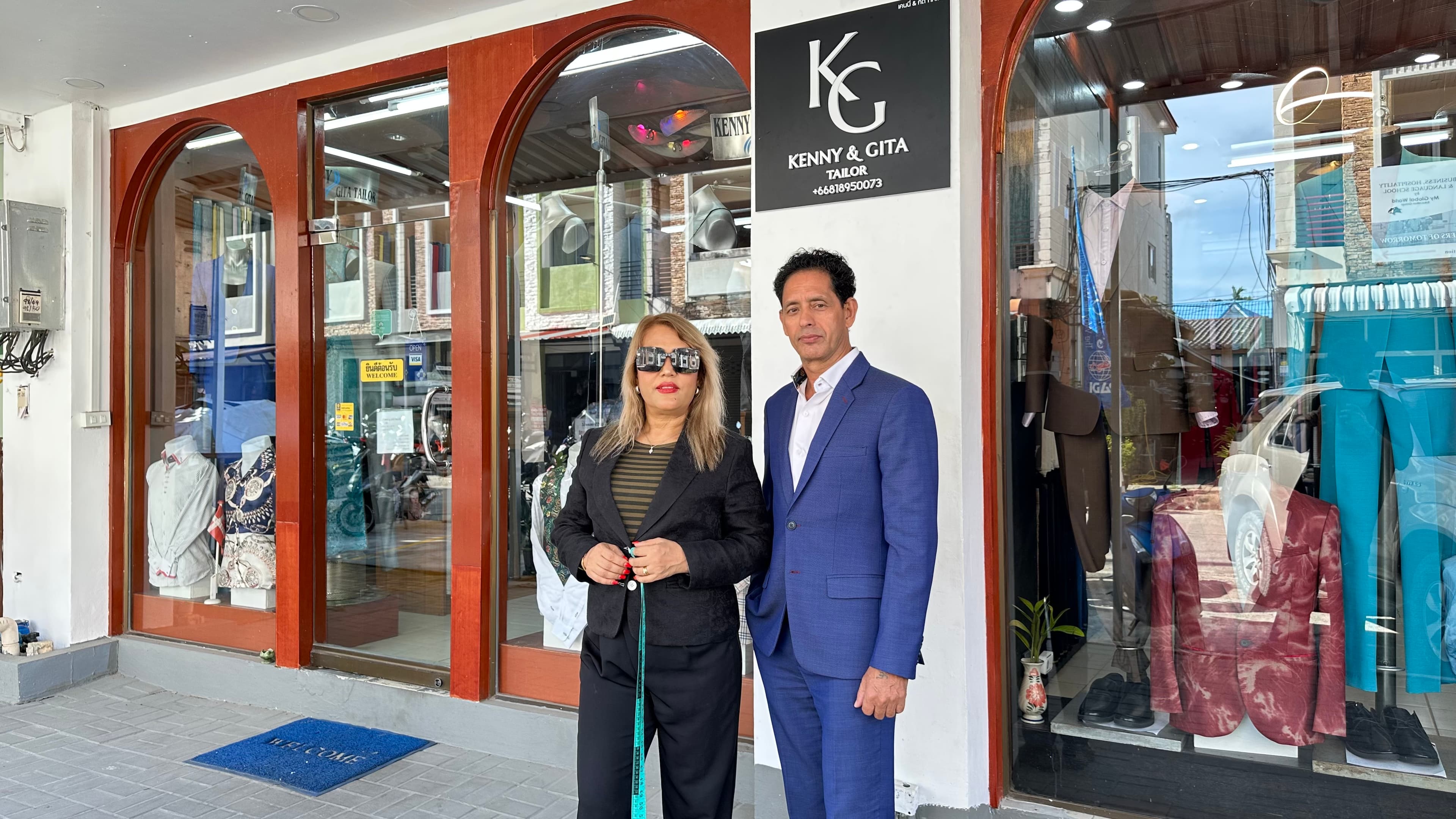 Kenny and Gita standing outside their only storefront in Kata