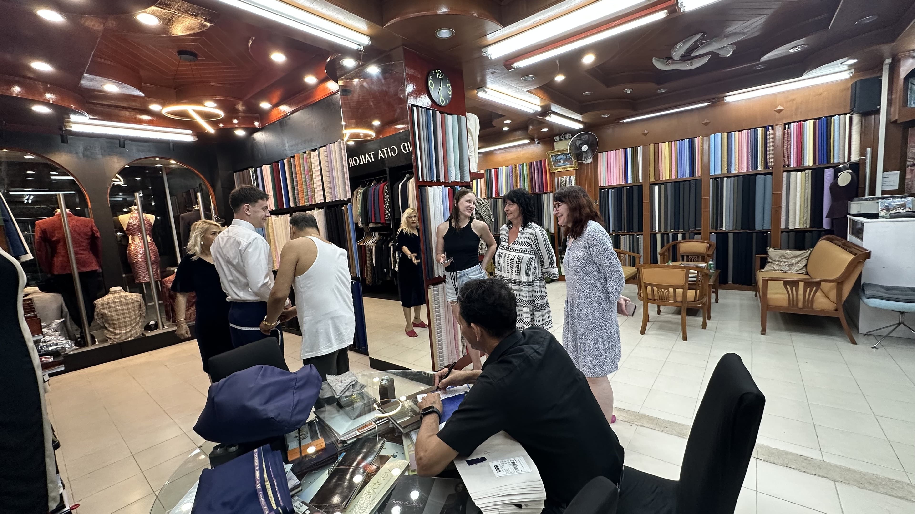 Clients taking part in a fitting and measurement consultation inside the Kata showroom
