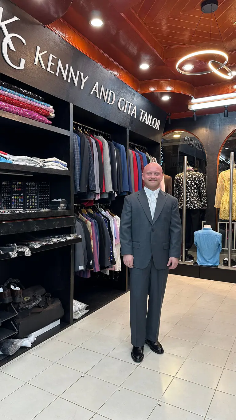 Client wearing a finished gray custom suit at Kenny & Gita Tailor in Phuket