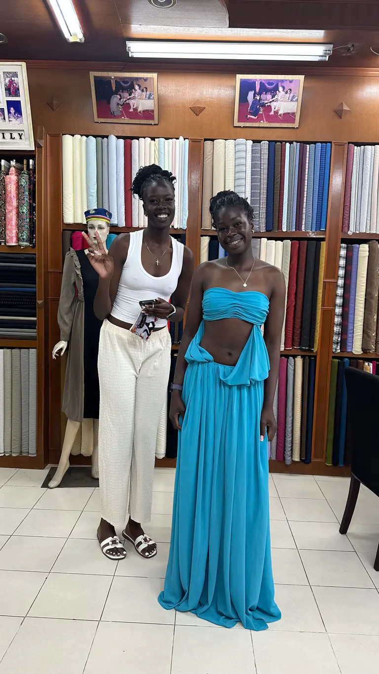 Two clients wearing special-occasion dresses tailored by Kenny & Gita Tailor in Phuket