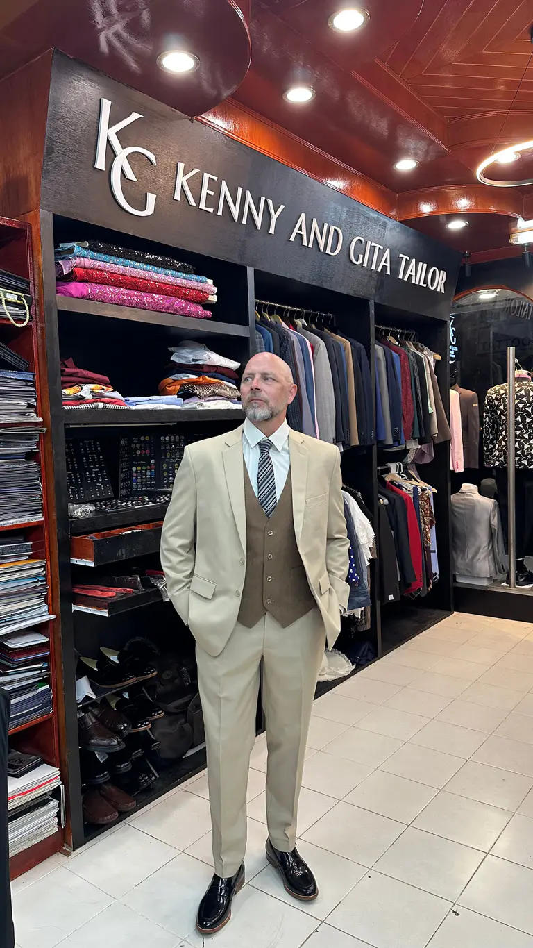 Client wearing a cream three-piece bespoke suit at Kenny & Gita Tailor in Kata, Phuket