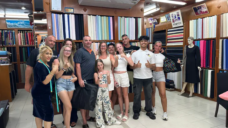 Family and friends visiting Kenny & Gita Tailor after a successful custom tailoring appointment