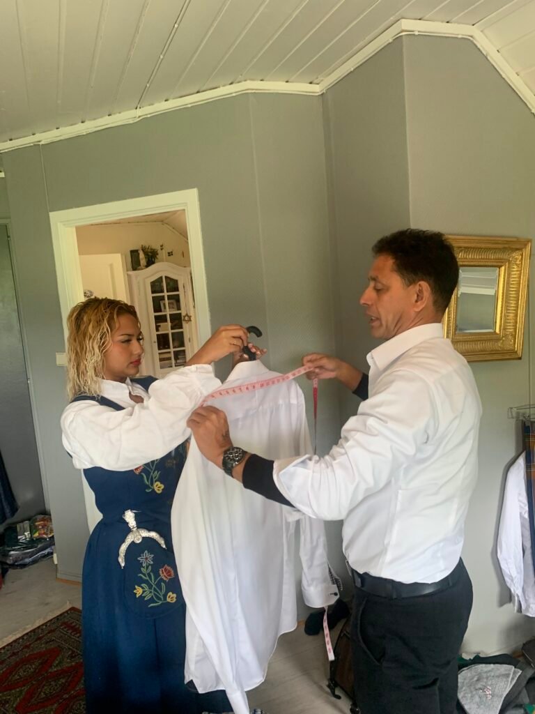 Demonstrating meticulous attention to detail, one of the best tailors from Phuket provides a personal, one-on-one fitting for a custom shirt. This image showcases the hands-on, bespoke service and commitment to a perfect fit that makes them a top choice for discerning clients worldwide.